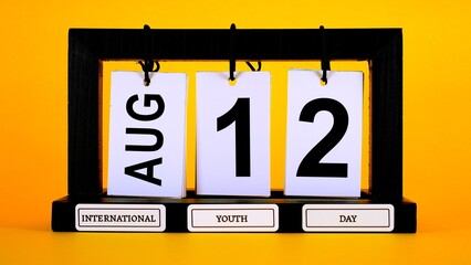 Perpetual calendar displaying the date of August 12th against a vibrant yellow background, highlighting International Youth Day as a celebration of young generations and their potential