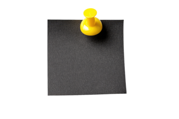 A square, matte black sticky note, affixed to a dark background with a bright yellow pushpin