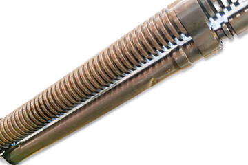 Close-up of metallic object with ridged cylindrical component, likely a mechanical part Shiny...