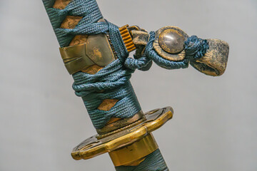 Close-up of a katana, traditional Japanese long sword Metallic blade with curved shape Blue...