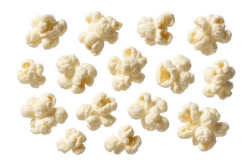 Multiple fluffy popped corn kernels scattered in an arrangement on transparent background.