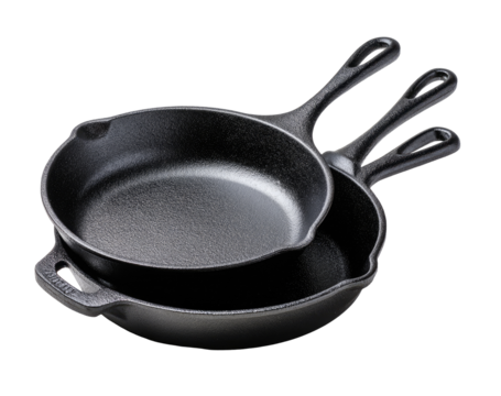 Two cast iron skillets, one nested inside the other, angled, showing handles