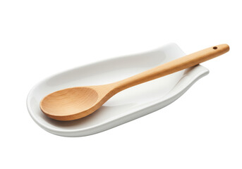Wooden Spoon Resting on a White Ceramic Spoon Rest, Isolated