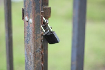 Locked metal gates fence and metal lock outdoor photo summer 