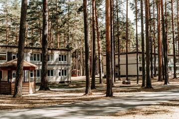 Old brick buildings Soviet pioneer camp on territory of desert pine forest park