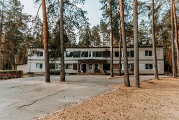Old brick buildings Soviet pioneer camp on territory of desert pine forest park
