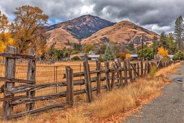 Autumnal rural scene with weathered fence and hilltop