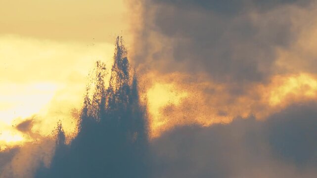 Close up slow motion of Old Faithful geyser in Yellowstone National Park erupting at sunset.