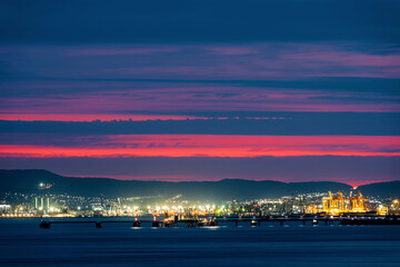 Fototapeta premium colorful sunset over the port of Novorossiysk on a summer evening