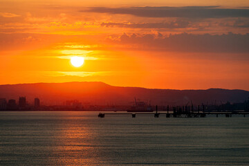 colorful sunset over the port of Novorossiysk on a summer evening