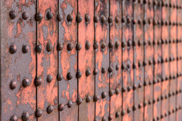 Detailed macro of aged rusty metal plates connected with rivets ideal for industrial background or texture