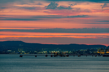 colorful sunset over the port of Novorossiysk on a summer evening