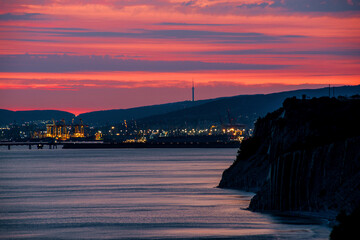 colorful sunset over the port of Novorossiysk on a summer evening