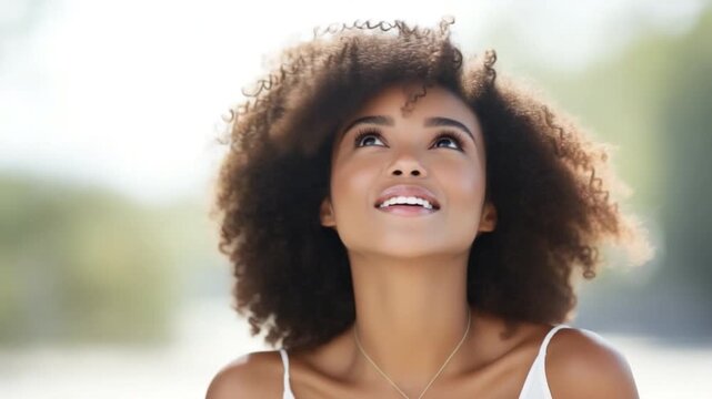 Skyward Gaze: A young woman with curly hair looks upwards, lost in thought or wonder, embodying a sense of freedom and hope.