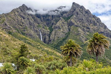 Mountainous landscape with waterfall and palms