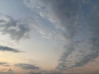 Dramatic sky at sunset with beautiful orange, blue, and grey clouds. A perfect natural background