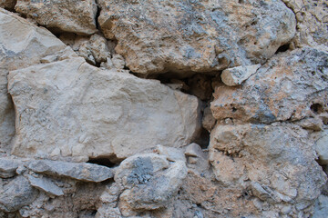 Ancient stone wall of a ruined Greek house in Crete