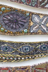 Colorful abstract glass mosaic artwork featuring intricate geometric and organic patterns, vibrant textures and diverse materials.