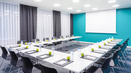 A modern conference room with a U-shaped table arrangement