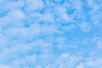Bright blue sky with fluffy white clouds on a sunny day. Perfect for backgrounds, weather concepts, and a sense of freedom and serenity