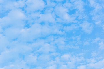 Bright blue sky with fluffy white clouds on a sunny day. Perfect for backgrounds, weather concepts, and a sense of freedom and serenity