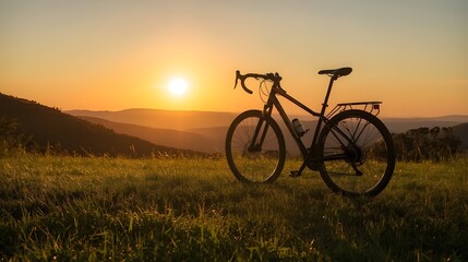 Fototapeta premium Bicycle on Green Hill at Sunset Lone Bike in Golden Light on Grass