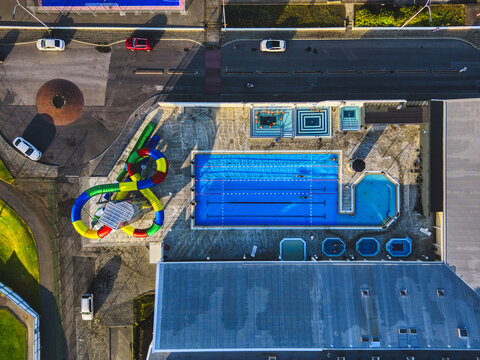 Keflav&Atilde;&shy;k, Iceland - 29 August 2023: Aerial view of the contrasting blues of pools and the bright colours of a waterslide create a vibrant scene at the swimming pool near 31 Sunnubraut.