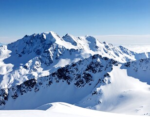 Snow-covered mountain peaks under a clear blue sky