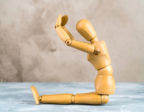 Wooden figurine in seated yoga pose - Powered by Adobe