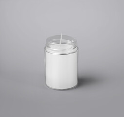 Mockup of a white wax candle in a glass jar, with a wick, aroma candle isolated on a background.