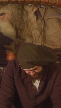 Merchant bargains with adventurers in tavern. Greedy obese seller makes profitable deal with pilgrims in medieval roadside pub. Fantasy characters interact
