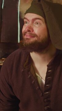 Bartender leaves work to listen customer in tavern. Attentive man with beard takes order from honorable guest in medieval inn. Fantasy role play game