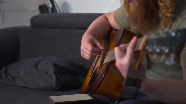 Nostalgic moment of a red-haired bard singing and playing acoustic guitar alone at home. Warm natural light, soft focus, and heartfelt expression evoke memories of intimate evenings and soulful songs.