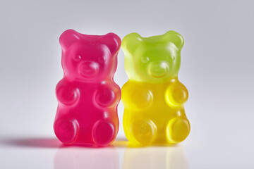 Colorful heart-shaped gummy bears with red, yellow, and white fruit flavors, symbolizing sweet love