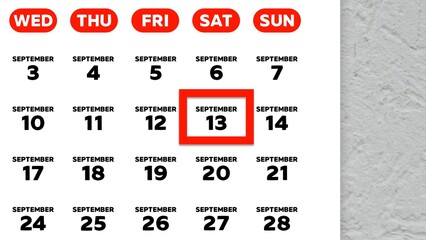 Close-up of the date September 13th marked with a red cursor on the wall calendar 2025