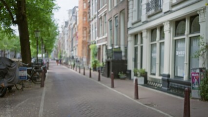 Defocused street view in amsterdam with blurred architecture and classic european urban scenery showcasing traditional dutch cityscape in serene daylight.