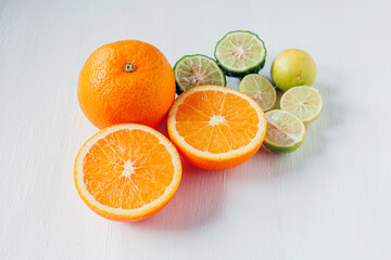 Citrus fruit of Halved orange fruit, slices lemon or lime fruit and bergamot fruit on white background,