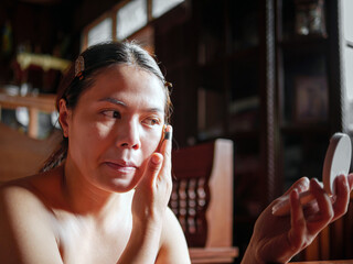 Beauty & Skincare, Beautiful woman sitting applying translucent face powder when doing make-up,...