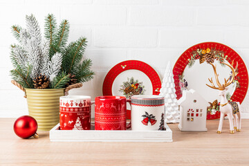 Cozy stylish interior design kitchen countertop decorated for the Christmas. A set of red dishes...