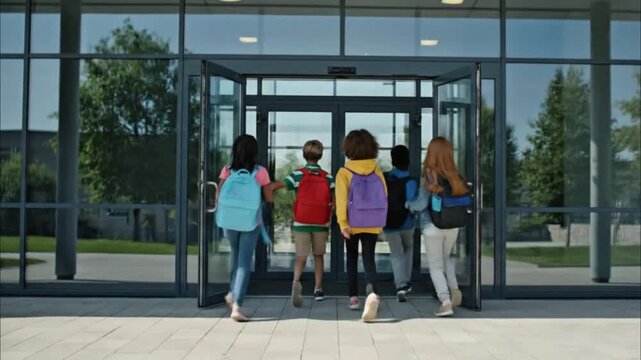 Children with backpacks entering modern school buildingChildren with backpacks entering modern school buildingChildren with backpacks entering modern school buildingChildren with backpacks entering mo