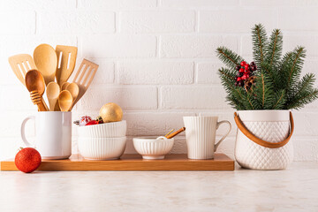 A beautiful marble kitchen countertop with a set of kitchen utensils and tools, decorated for the New Year holidays in a minimalist style. Front view.