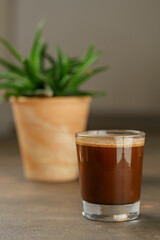 Beautiful Healthy Adaptogenic Drink in Glass, Trendy Vegan Elixir in Kraft Packaging on Rustic Table, Cozy Lifestyle Shot