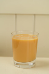 Beautiful Healthy Adaptogenic Drink in Glass, Trendy Vegan Elixir in Kraft Packaging on Rustic Table, Cozy Lifestyle Shot