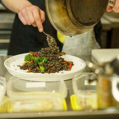 Vegan Chef Cooking Photography - Sizzling Plant-Based Gluten-Free Food with Seasonal Veggies & Black Quinoa and Zucchini Salad in Professional Kitchen - Sustainable Cuisine
