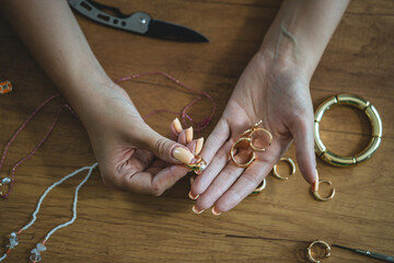 female hands hold handmade hammered rings