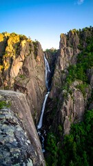 Fototapeta premium Waterfall cascading down a rocky canyon