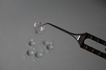 Surgical tool holding a clear contact lens.