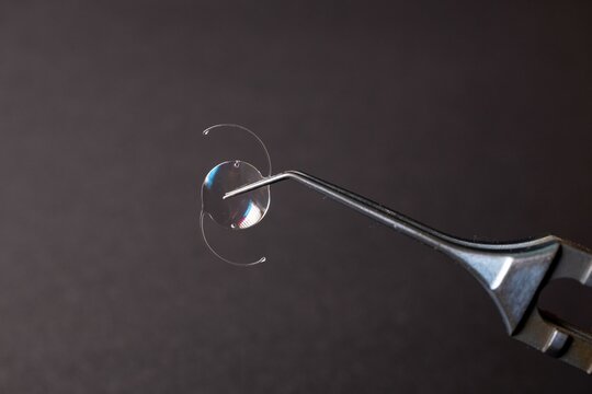 Intraocular lens held by surgical instrument.