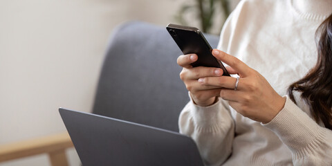 Digital Communication. Young woman texting on smartphone while working.