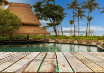 Wooden table top on the beach or sea. swimming pool Party on the beach  sunshine time concept.For montage product display or design key visual layout.View of copy space.